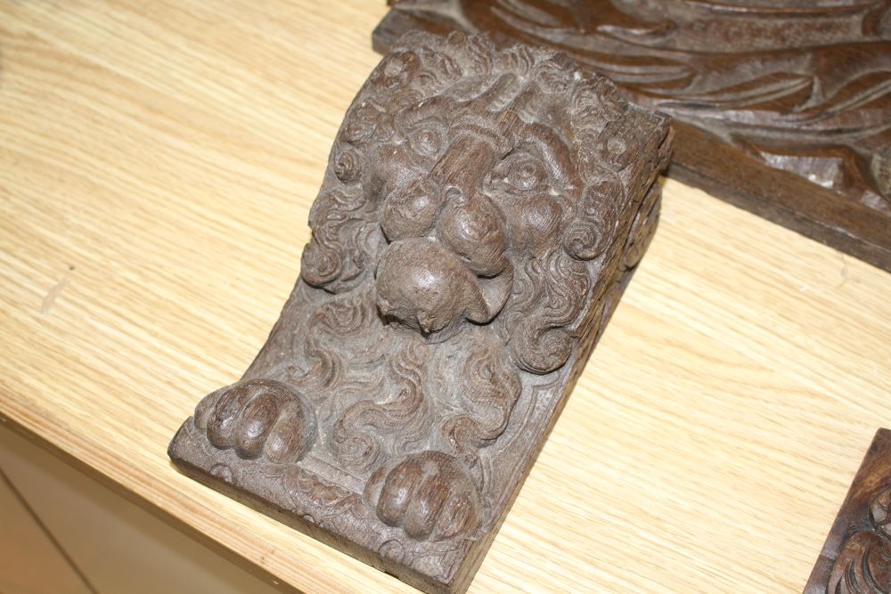 Three 19th century Continental carved oak corbels, carved with lion masks and a pair of scroll and dragon carved frieze panels
